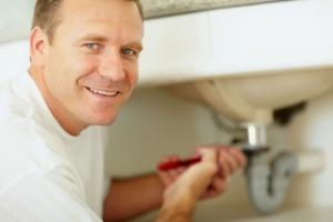 a Gilroy plumbing contractor is repairing a clogged sink